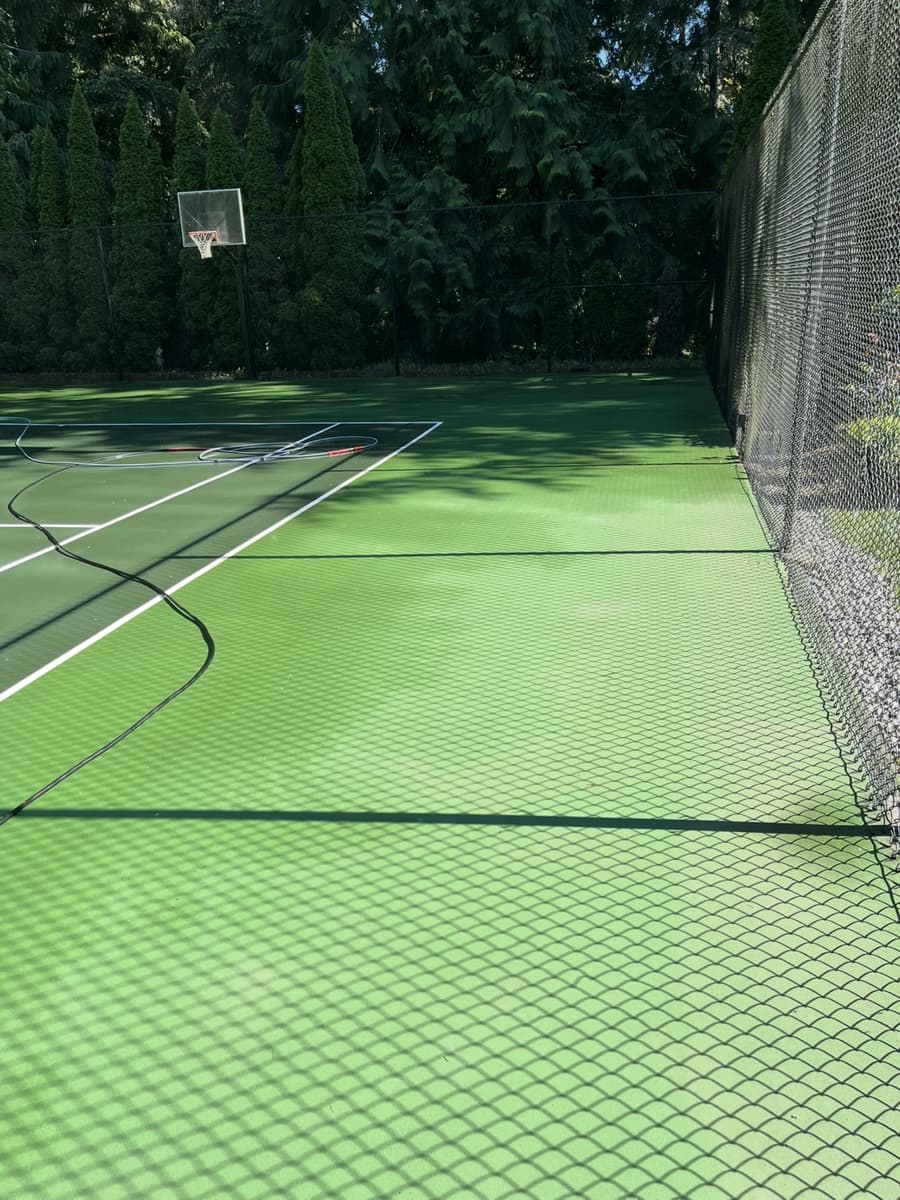 The same sport court after cleaning, bright green and spotless
