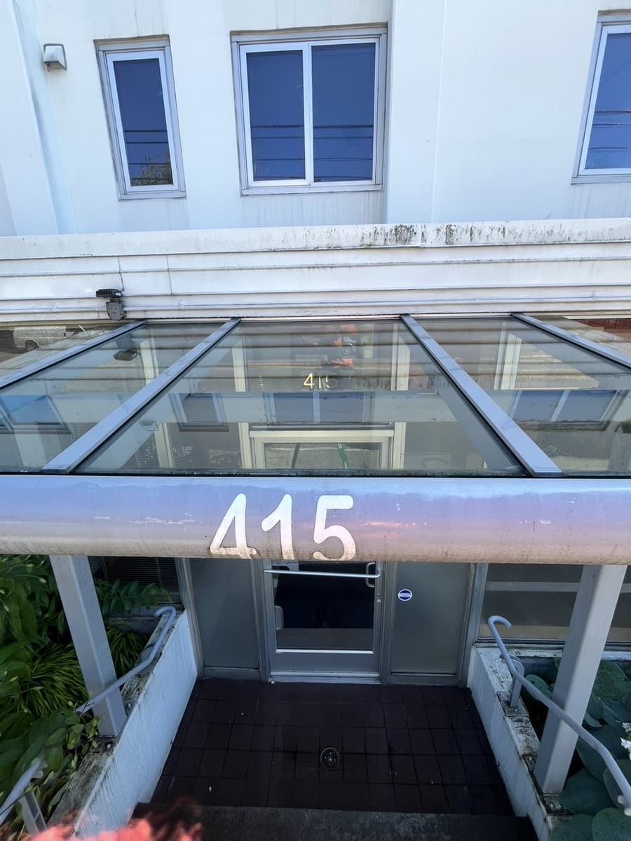 Apartment building entrance with glass canopy