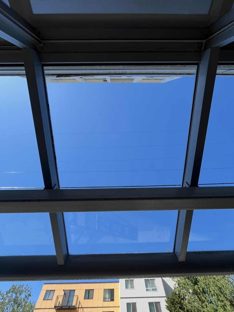 Glass canopy panels at an apartment entrance